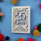 Silver anniversary Card with '25 Years Kelly and Ryan' on a blue background with colourful pom-poms.