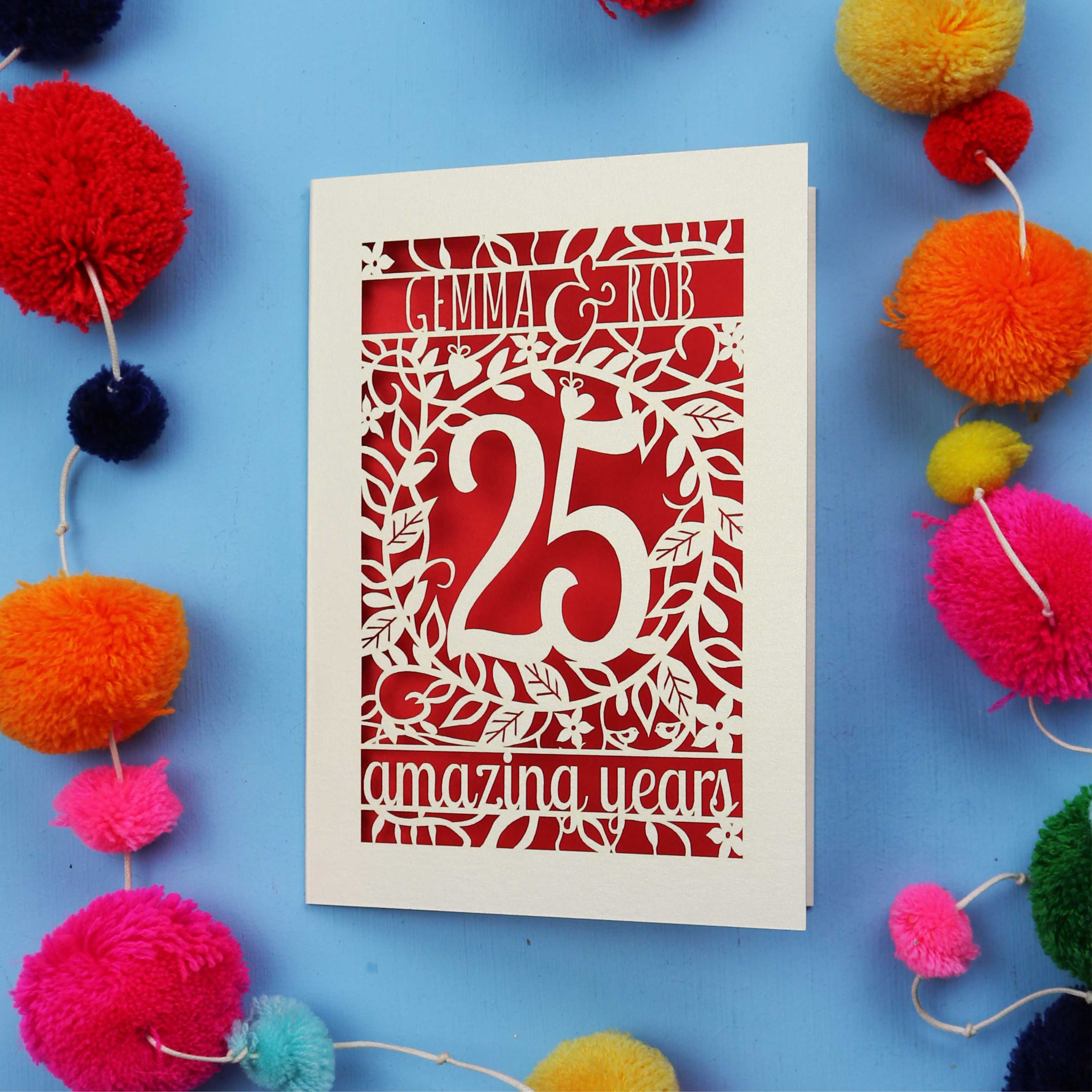 25th wedding anniversary Card with '25 amazing years' text on a blue background with colourful pom-poms.