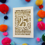 Silver wedding anniversary Card with '25 amazing years' text on a blue background with colourful pom-poms.