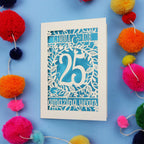 Silver wedding anniversary Card with '25 amazing years' text on a blue background with colourful pom-poms.