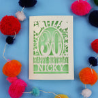 30th Birthday card with 'Happy Birthday Nicky' on a blue background with colourful pom-poms.