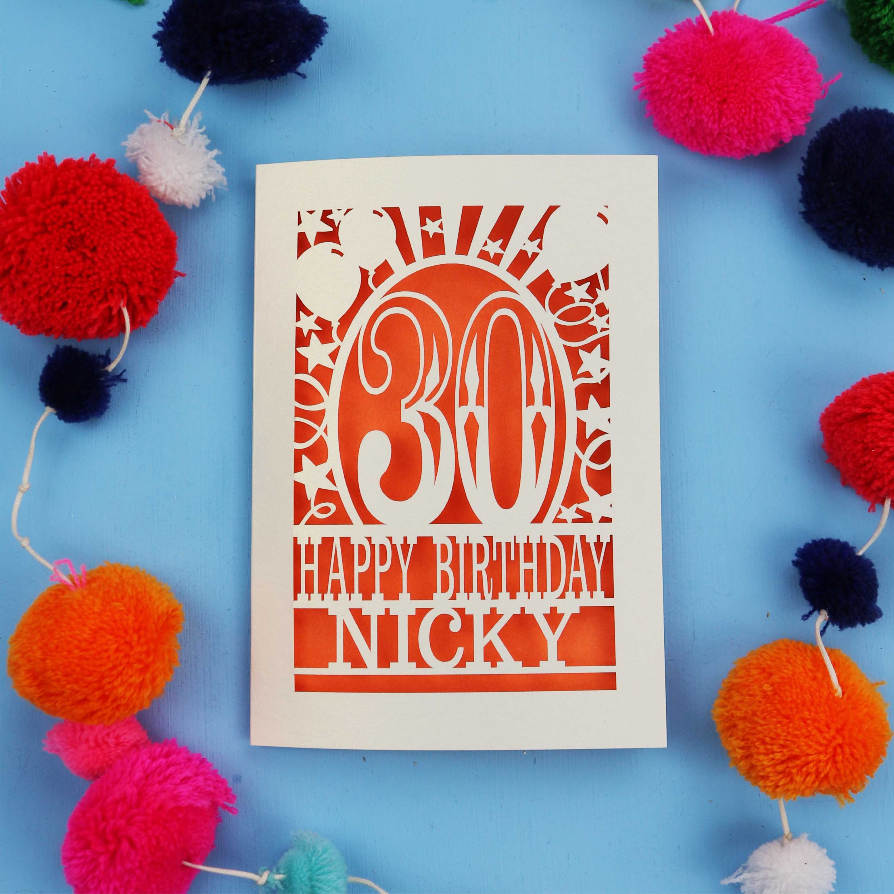 30th Birthday card with 'Happy Birthday Nicky' on a blue background with colourful pom-poms.