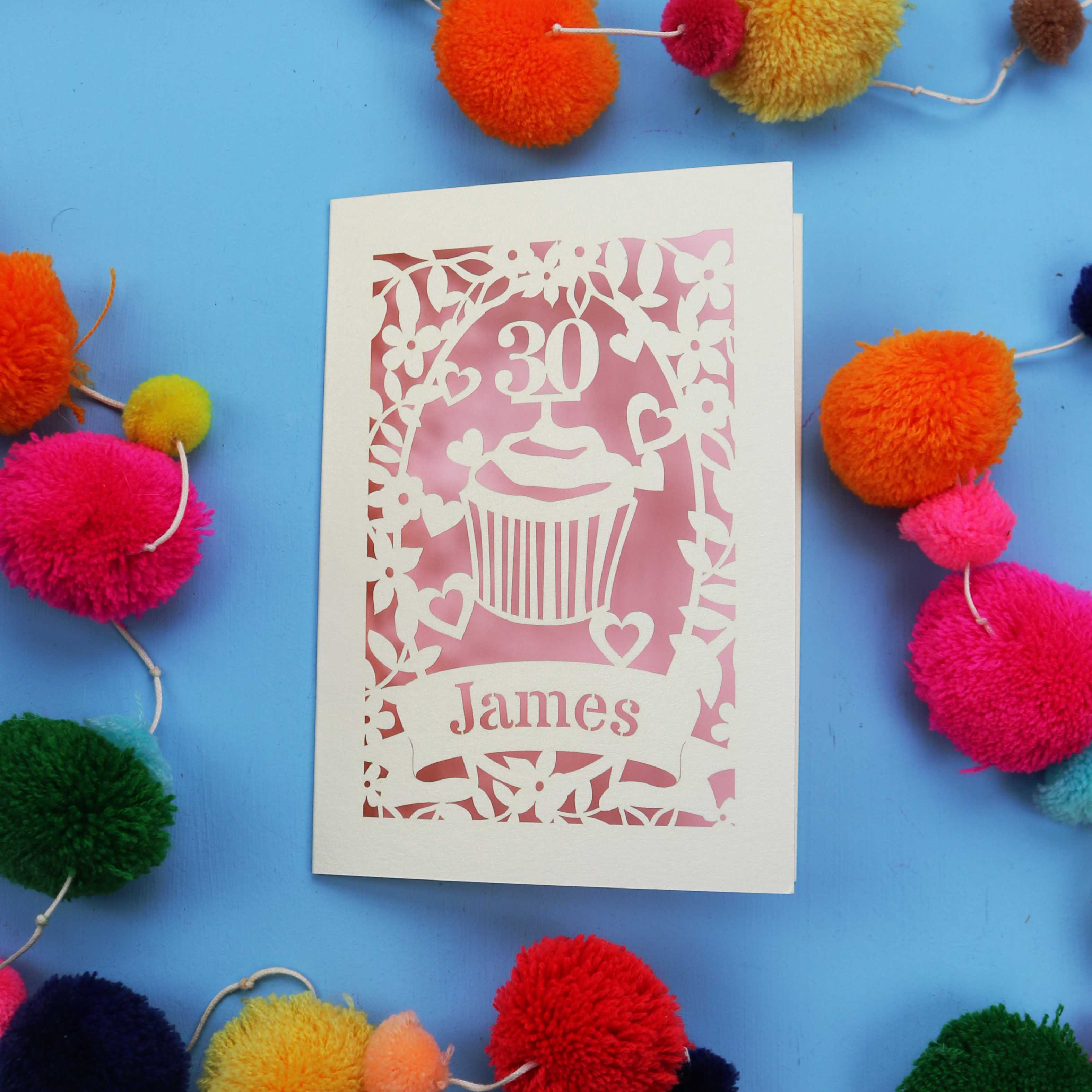 30th Birthday Card with '30 James' design on a blue background with colourful pom-poms.