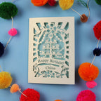 Decorative 30th birthday card with colourful pom-poms on a blue 