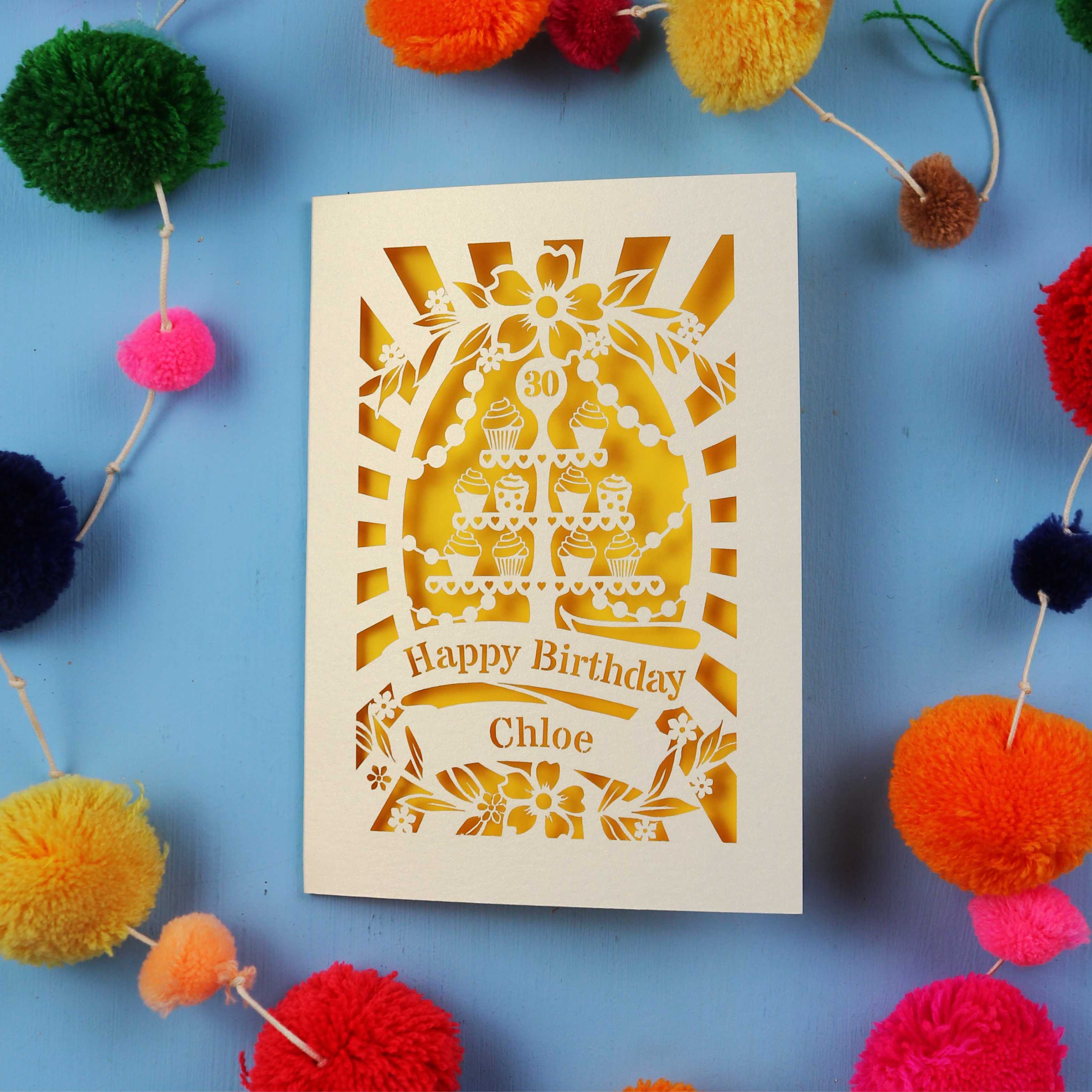 Decorative 30th birthday card with colourful pom-poms on a blue 