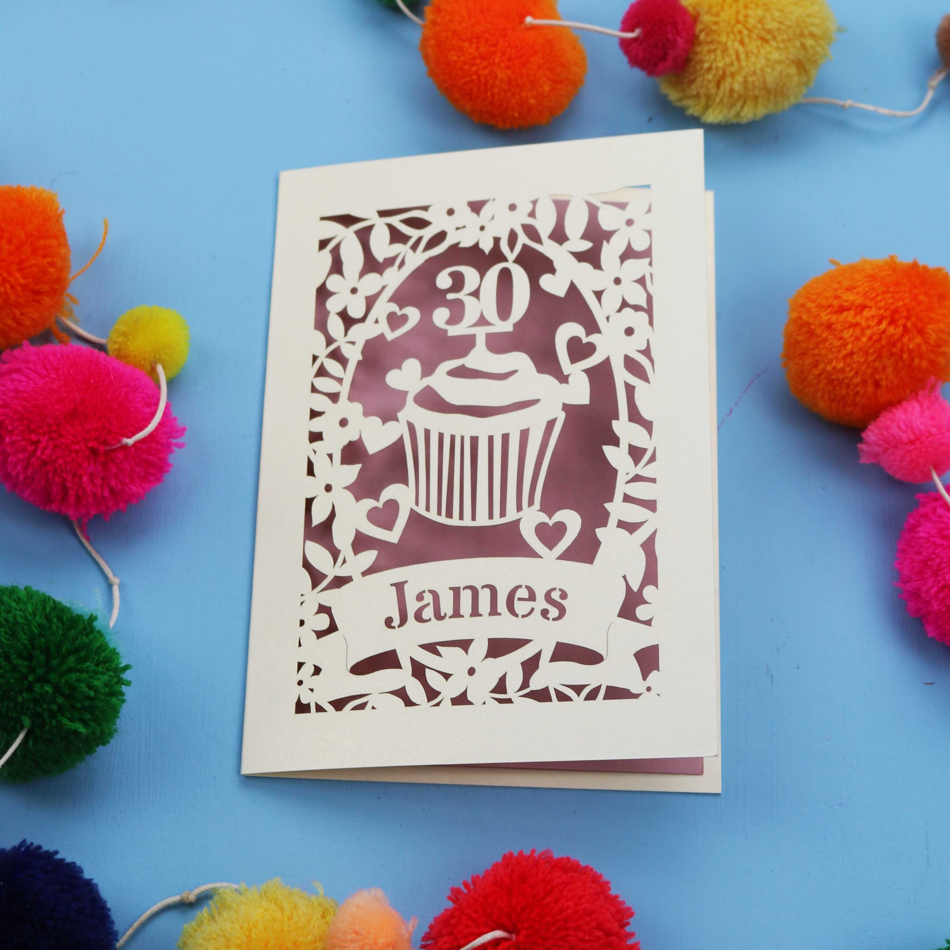 30th Birthday Card with '30 James' design on a blue background with colourful pom-poms.