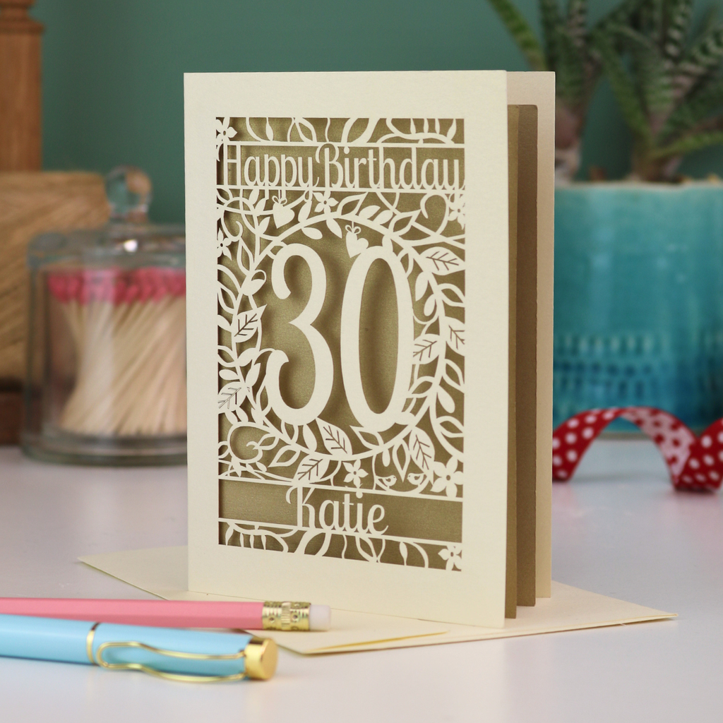 A laser cut 30th birthday card with floral cut out design, "Happy Birthday", 30, and personalised with a name. 