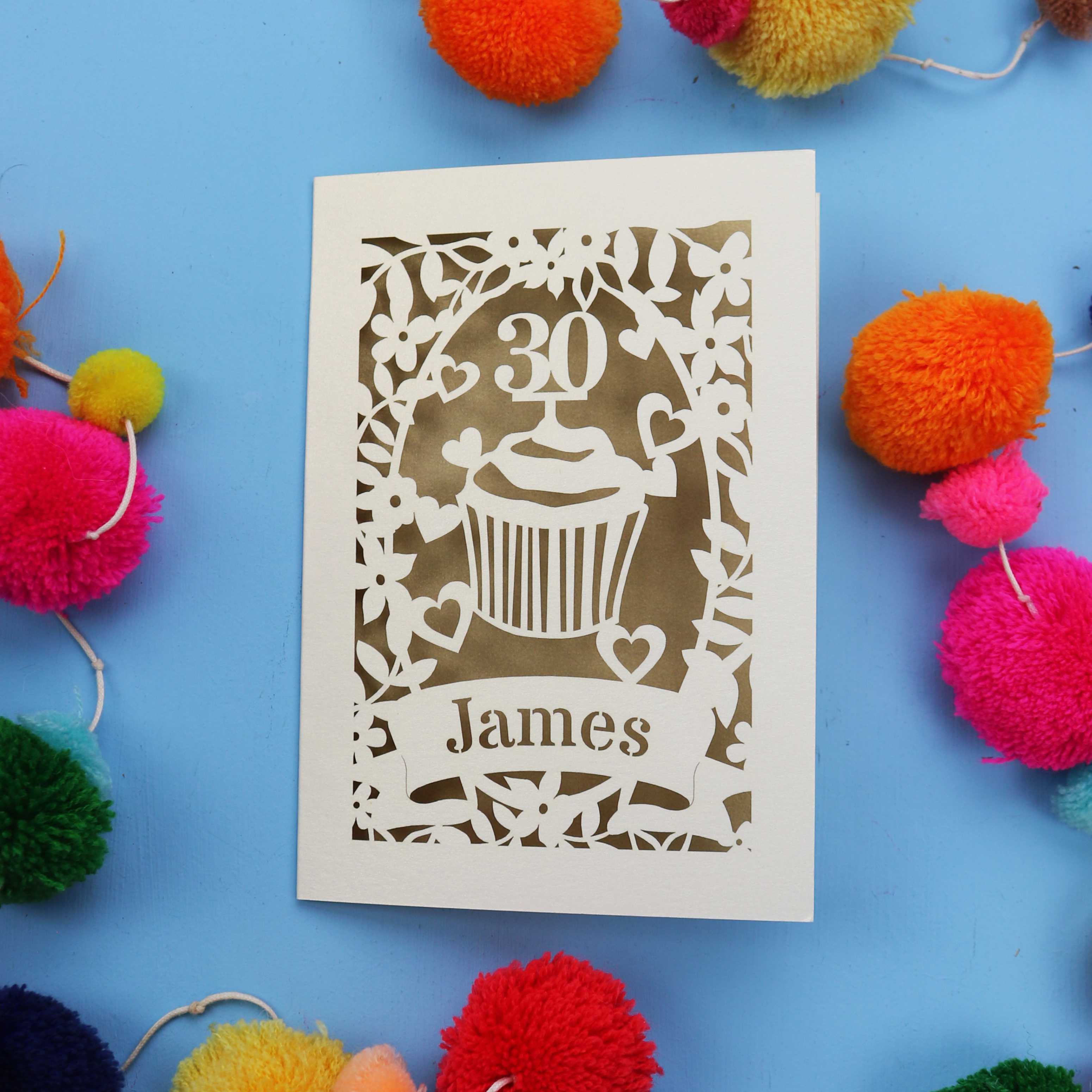 30th Birthday Card with '30 James' design on a blue background with colourful pom-poms.