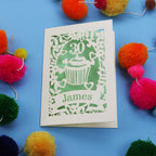 30th Birthday Card with '30 James' design on a blue background with colourful pom-poms.