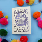 30th Birthday Card with '30 James' design on a blue background with colourful pom-poms.