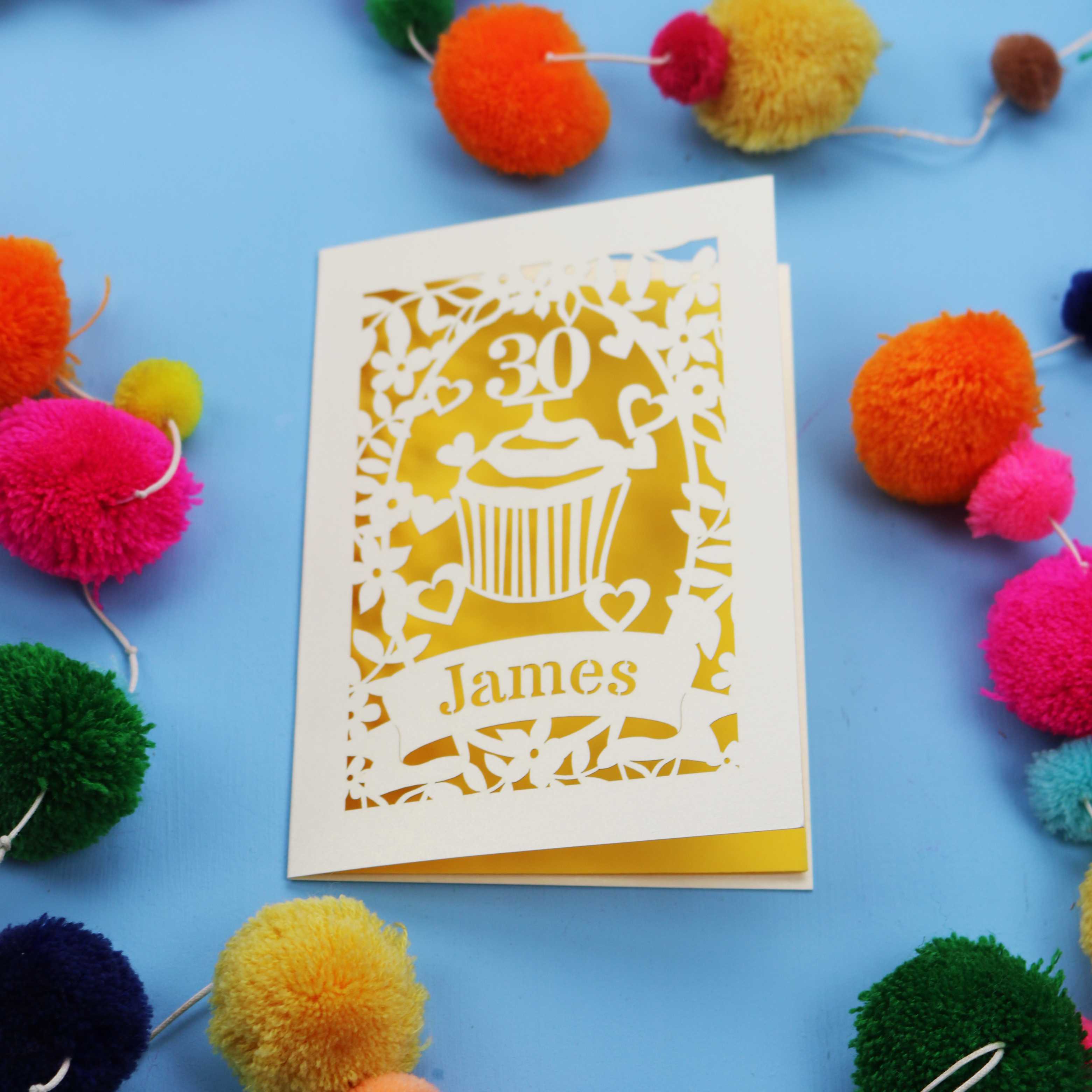 30th Birthday Card with '30 James' design on a blue background with colourful pom-poms.