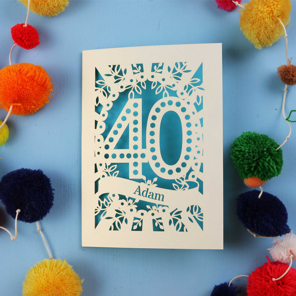 Laser cut 40th Birthday Card with '40' design on a blue background with colourful pom-poms