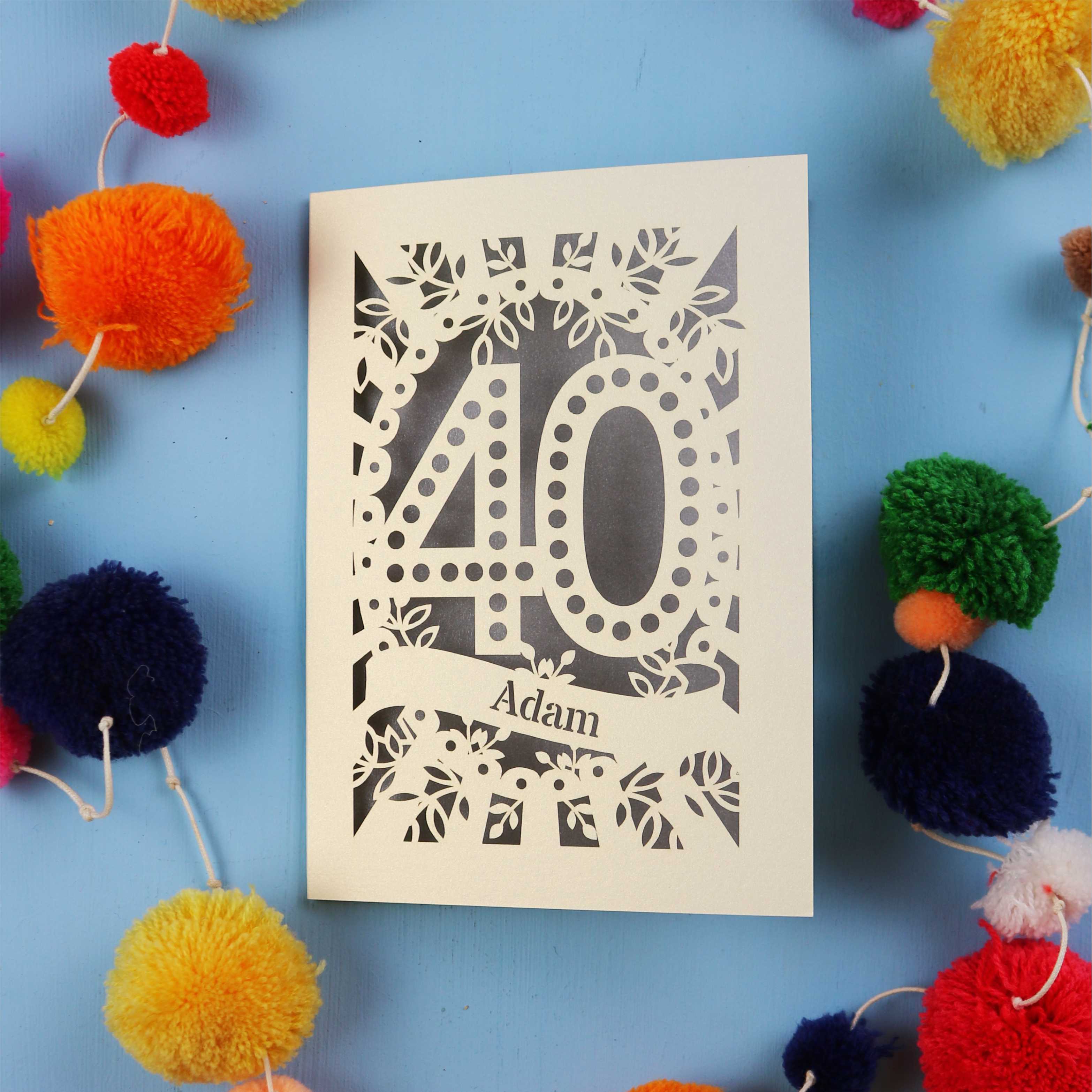 Laser cut 40th Birthday Card with '40' design on a blue background with colourful pom-poms