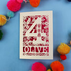 Woodland themed personalised 4th birthday card with number '4' and 'OLIVE' text on a blue background with colourful pom-poms.