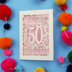 50th wedding Anniversary Card with '50 amazing years' design on a blue background with colourful pom-poms.