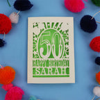 Happy 50th birthday card with colourful pom-poms on a blue background