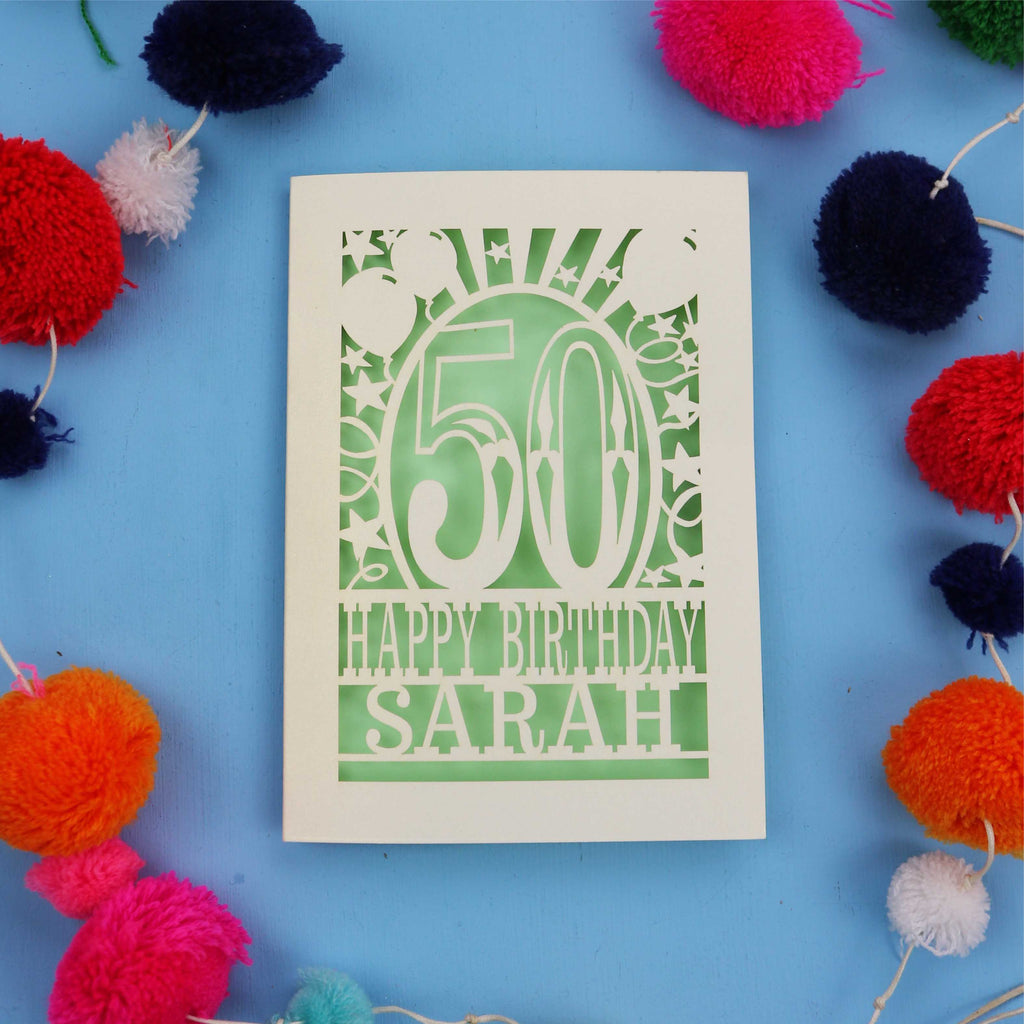 Personalised Happy 50th birthday card with colourful pom-poms on a blue background