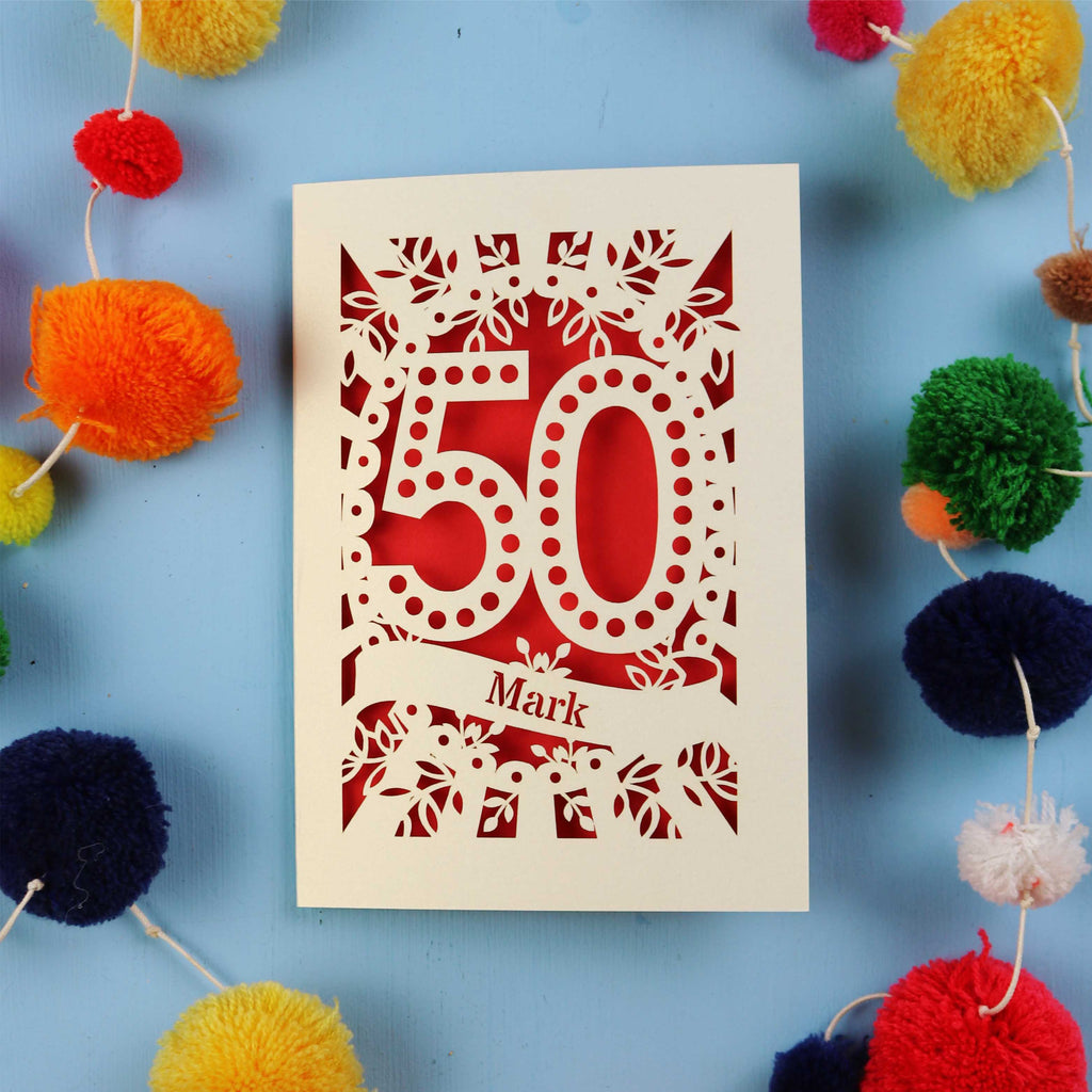50th Birthday Cards for men, with '50' laser cut design on a blue background with colourful pom-poms.