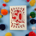 50th Birthday Cards for men, with '50' laser cut design on a blue background with colourful pom-poms.