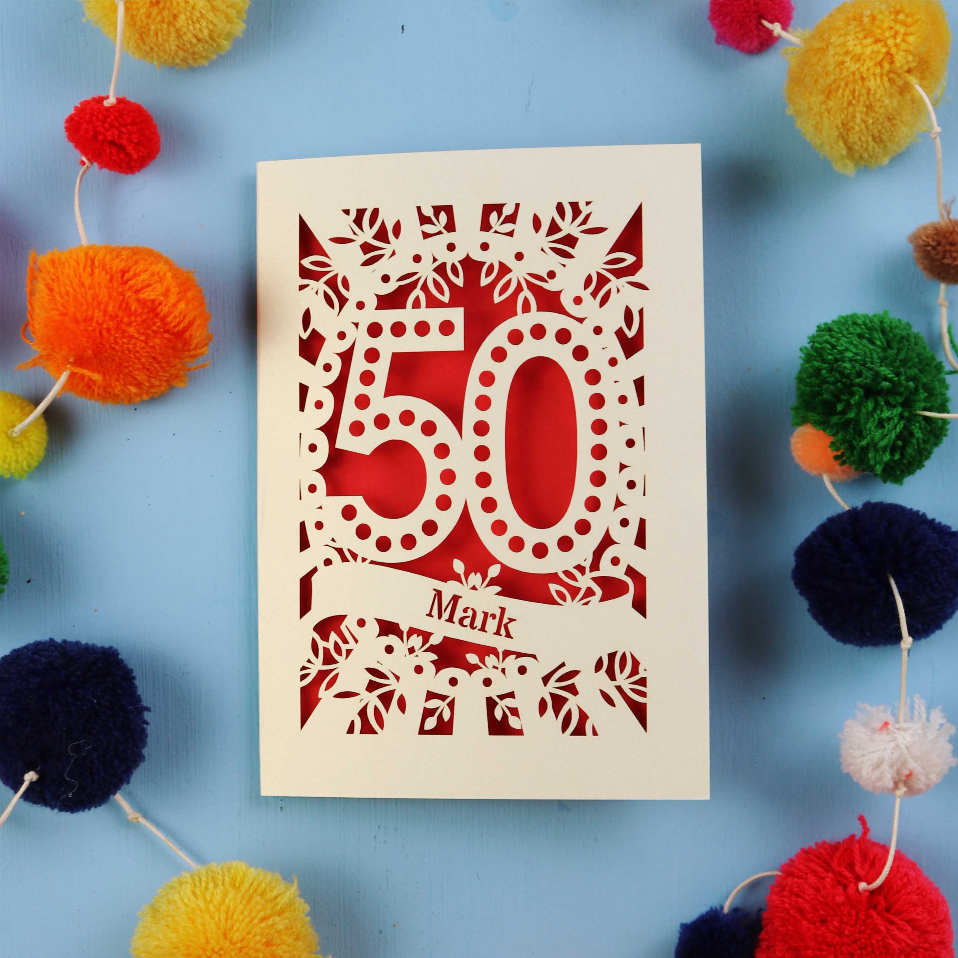 50th Birthday Cards for men, with '50' laser cut design on a blue background with colourful pom-poms.