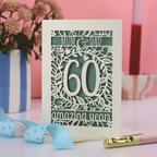 Laser cut anniversary Card with 'Mum & Dad, 60 amazing years' text on a pink background
