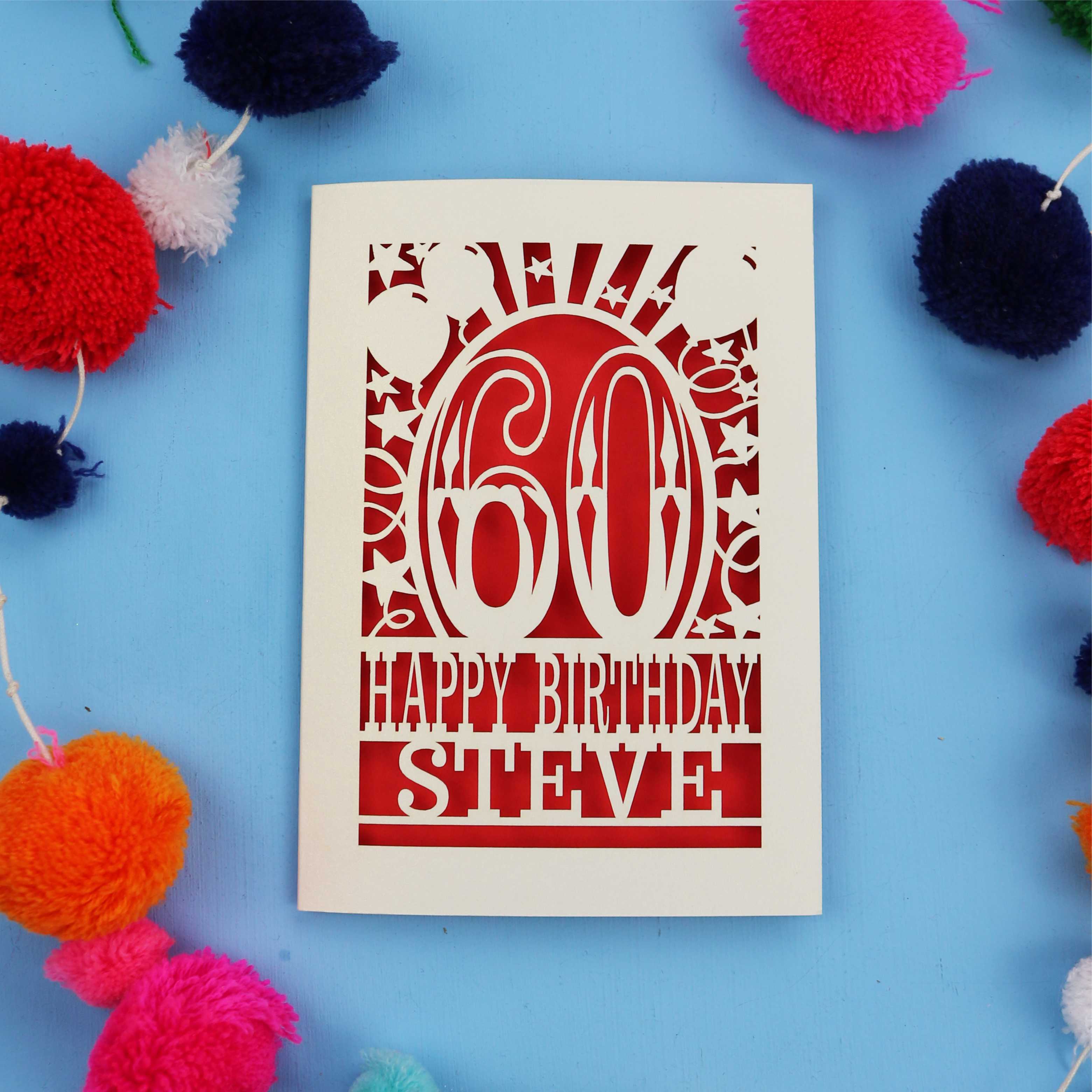 60th Birthday card with '60 Happy Birthday Steve' on a blue background with colourful pom-poms.