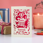 A personalised birthday card with laser cut cupcake design, age and name.