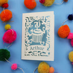 A laser cut 70th birthday card with cupcake design and personalised with a name