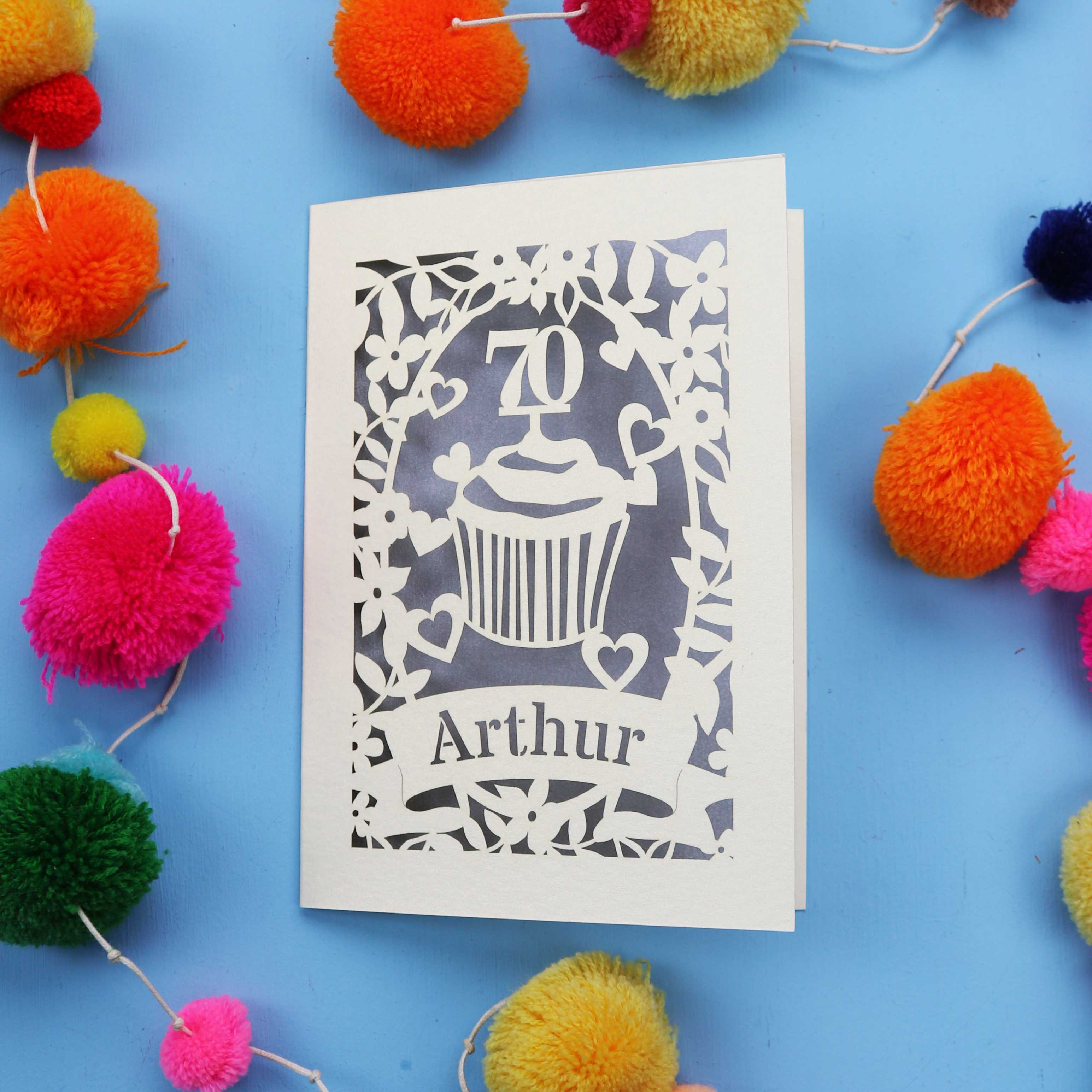 A laser cut 70th birthday card with cupcake design and personalised with a name