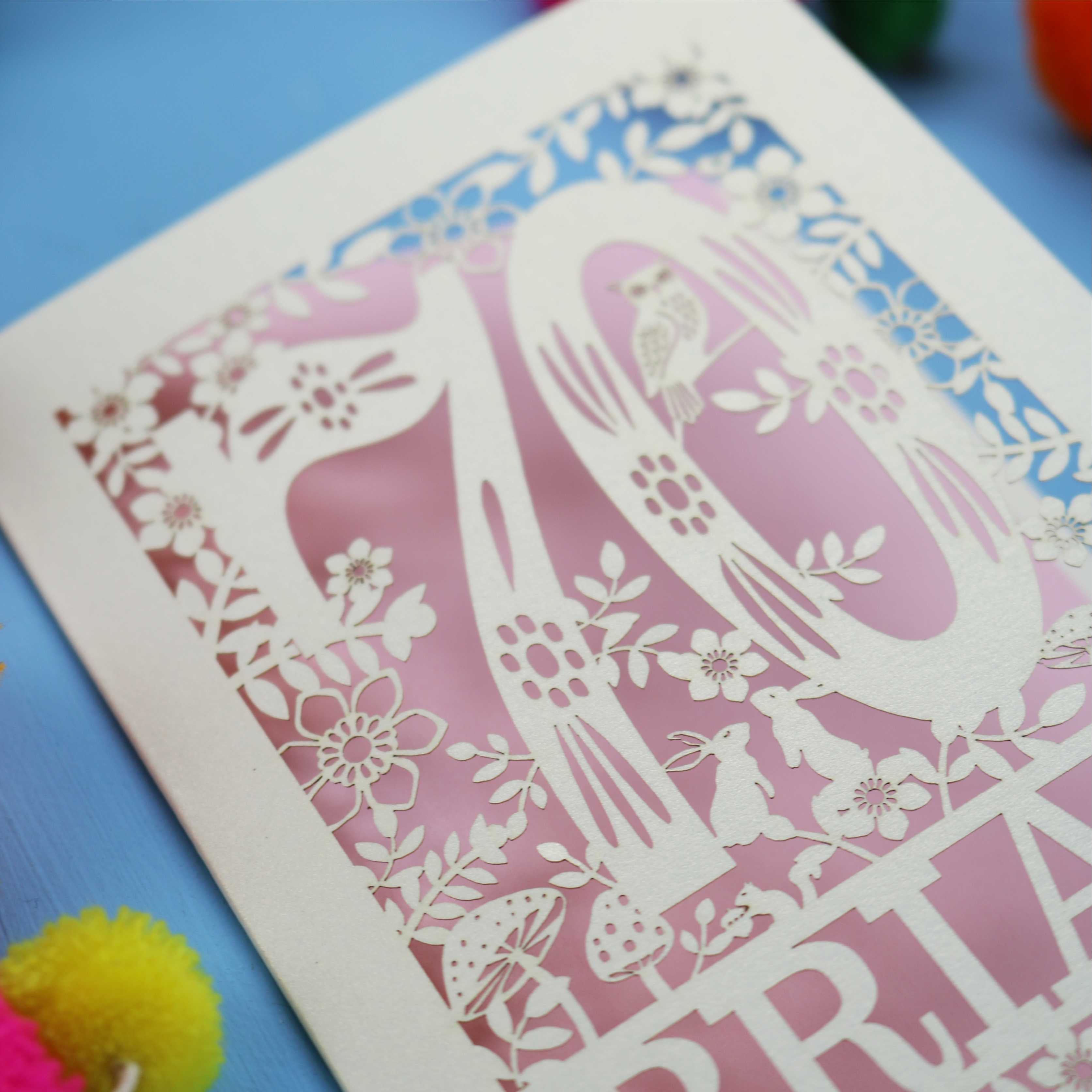 A personalised laser cut 70th birthday card featuring the number 70 and woodland cut out details. 