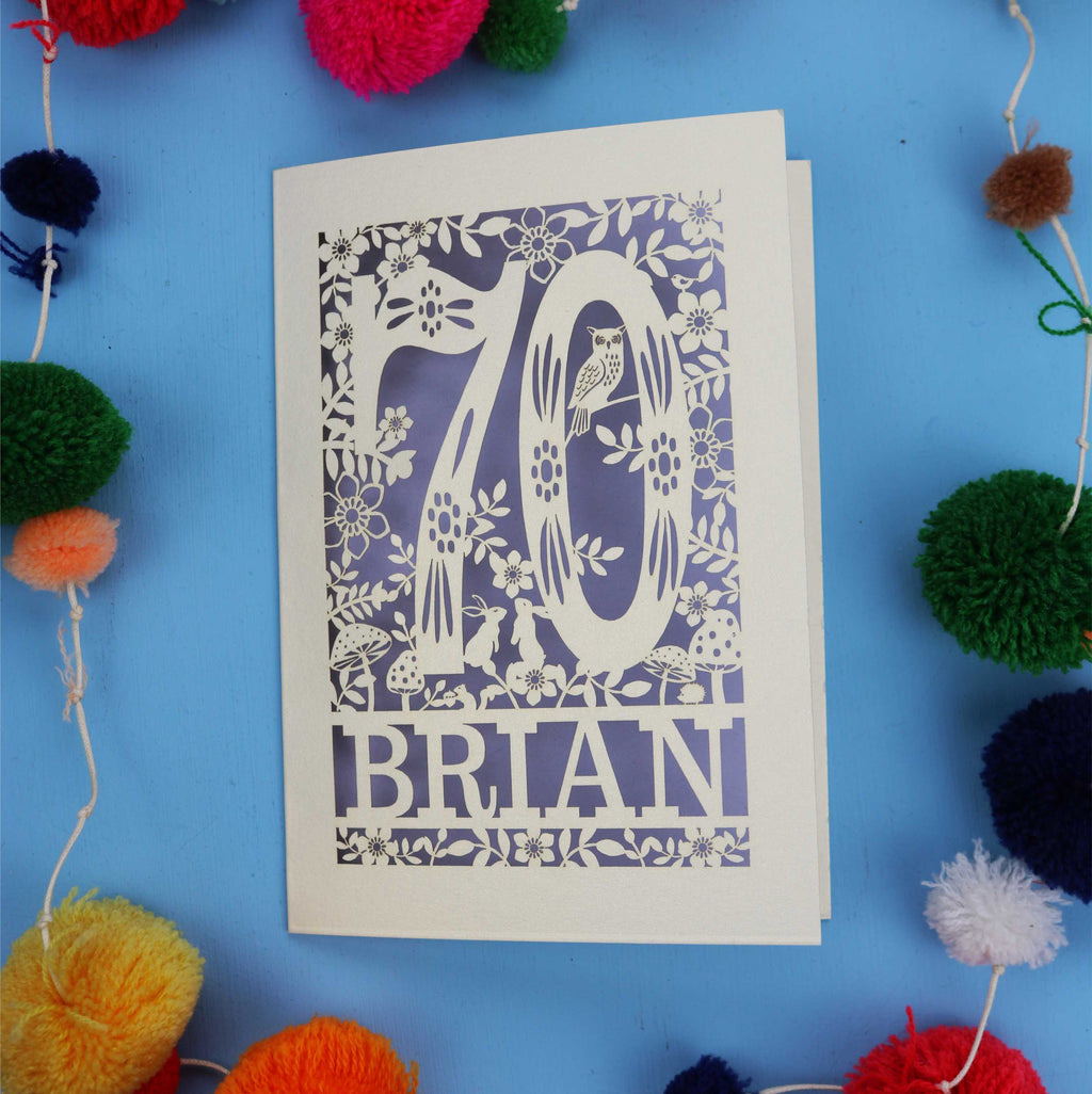 A personalised laser cut 70th birthday card featuring the number 70 and woodland cut out details. 