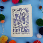 A personalised laser cut 70th birthday card featuring the number 70 and woodland cut out details. 