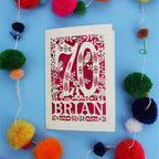 A personalised laser cut 70th birthday card featuring the number 70 and woodland cut out details. 