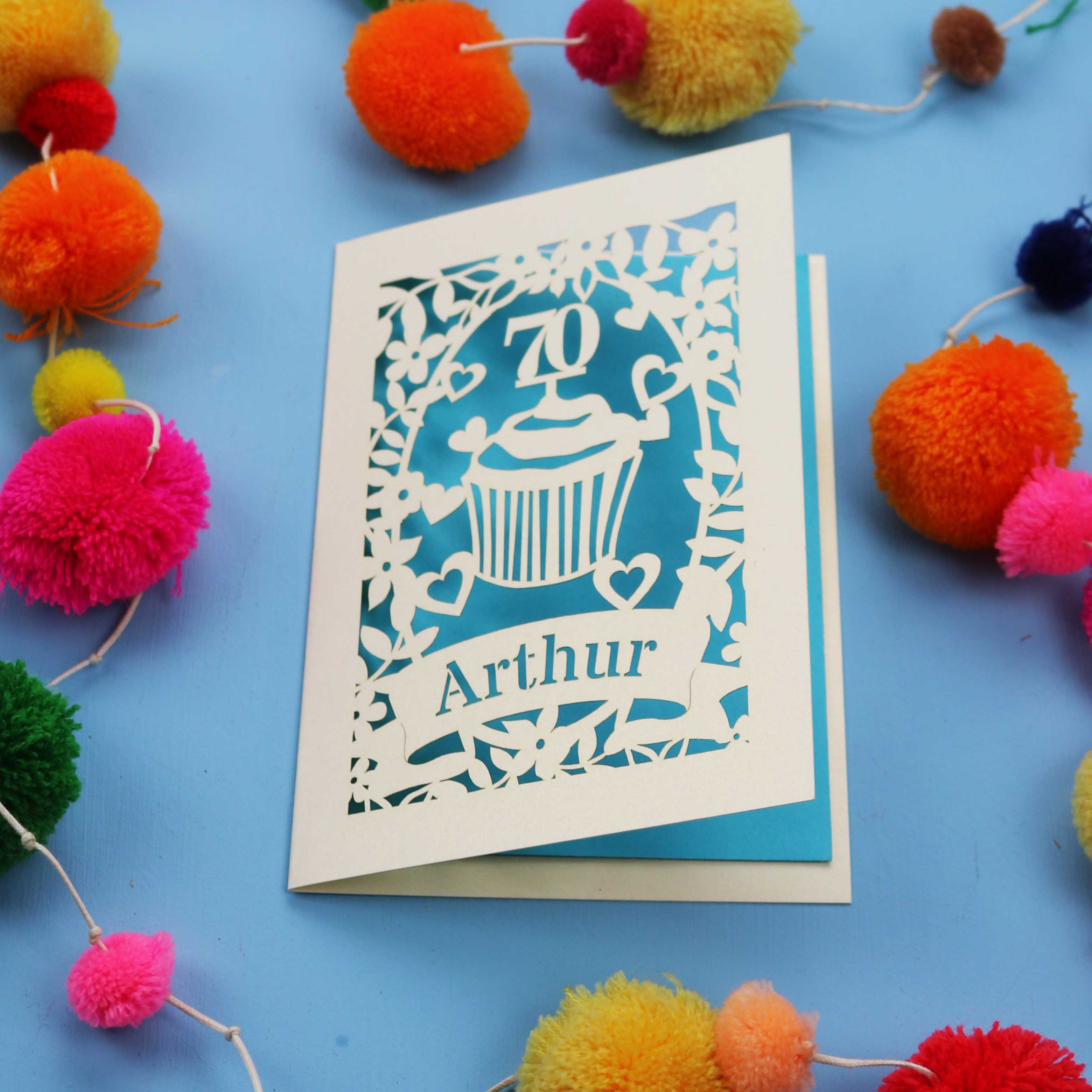 A laser cut 70th birthday card with cupcake design and personalised with a name