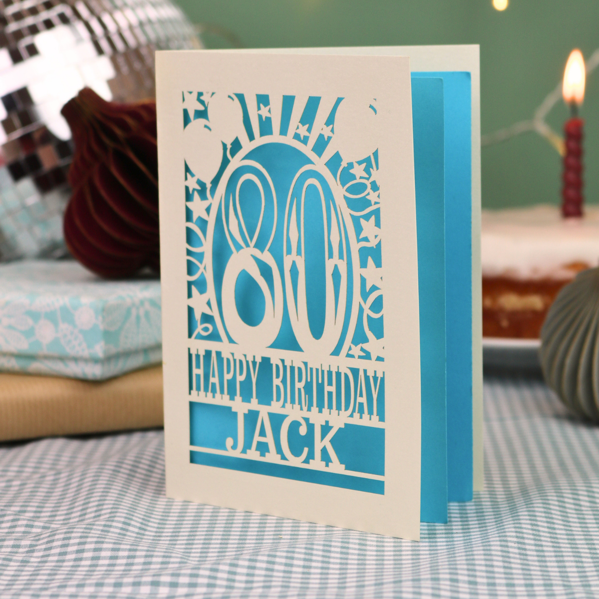 A personalised birthday card for 80th birthday, with decorative number '80' and text, 'Happy Birthday Jack', and a cut out border with stars and balloons. 