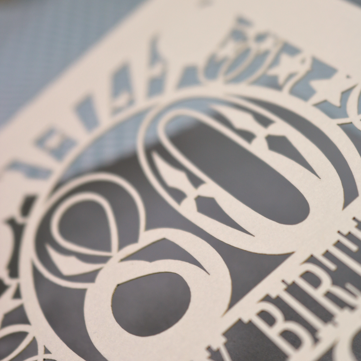 A personalised birthday card for 80th birthday, with decorative number '80' and text, 'Happy Birthday Jack', and a cut out border with stars and balloons. 