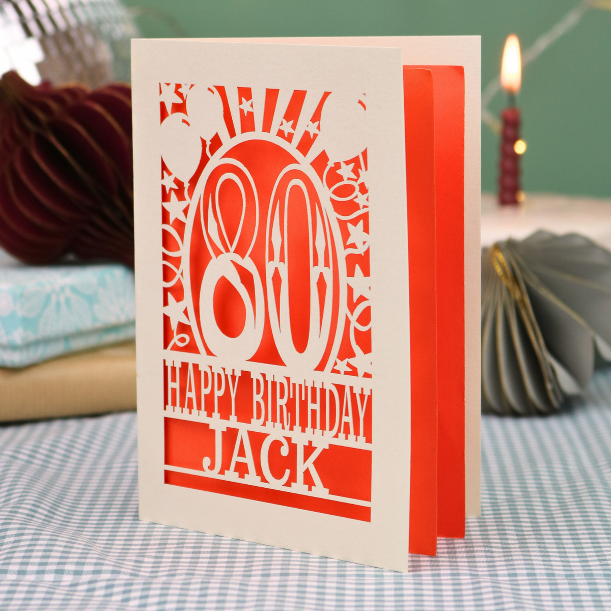A personalised birthday card for 80th birthday, with decorative number '80' and text, 'Happy Birthday Jack', and a cut out border with stars and balloons. 