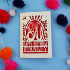 80th Birthday card with 'Happy Birthday Stanley' on a blue background with colourful pom-poms.