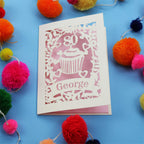 Cake themed 80th Birthday Card with '80' cut out cupcake design on a blue background with colourful pom-poms.