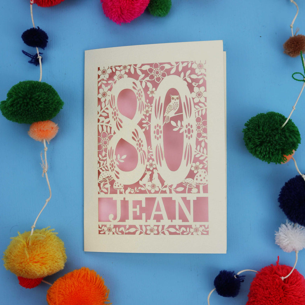 Special 80th Birthday card with '80 Jean' design on a blue background with colourful pom-poms.