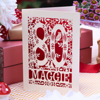 A personalised 80th birthday card. laser cut with the number 80 surrounded by floral elements and woodland creatures, personalised with the name Maggie'