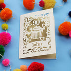 Decorative keepsake 90th birthday card with '90' and 'John' on a blue background with colourful pom-poms.