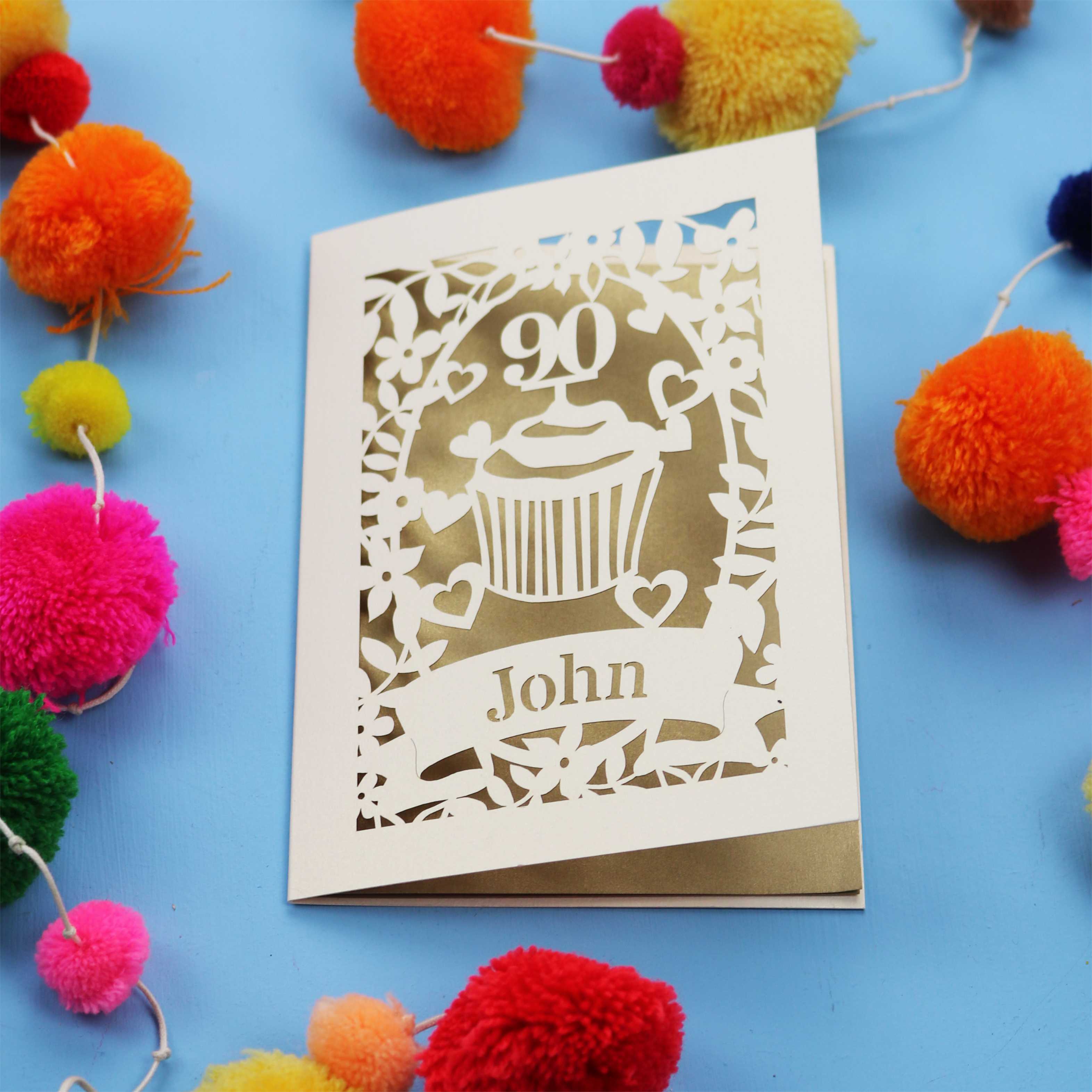 Decorative keepsake 90th birthday card with '90' and 'John' on a blue background with colourful pom-poms.