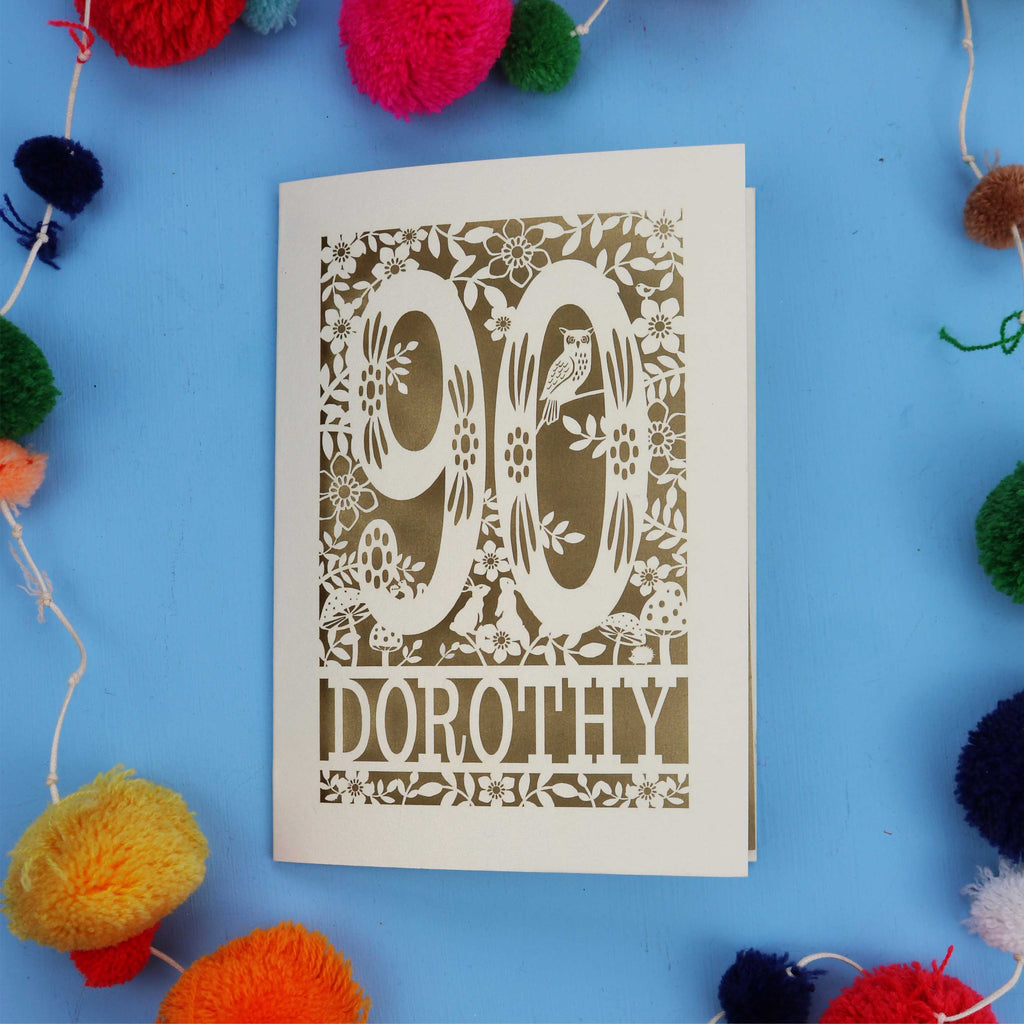 90th Birthday Card with '90 Dorothy' design on a blue background with colourful pom-poms.