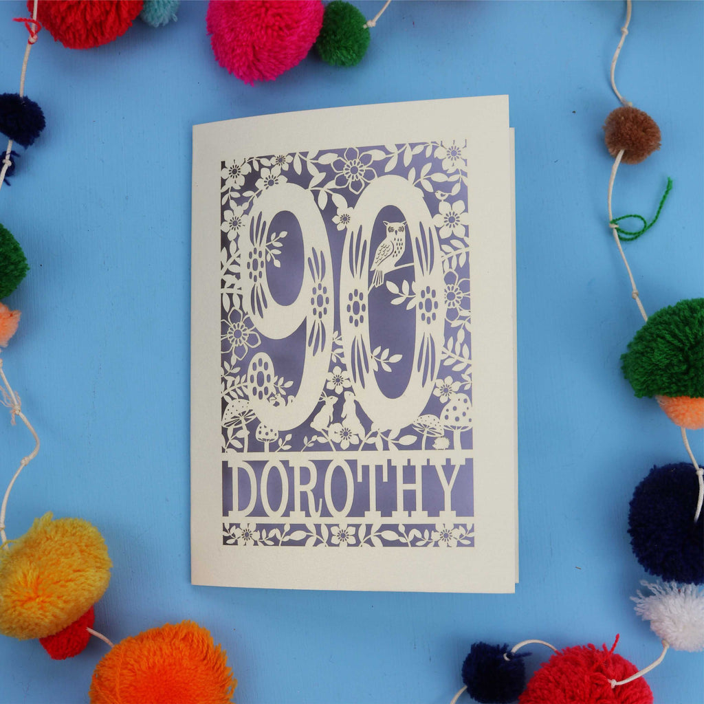 90th Birthday Card with '90 Dorothy' design on a blue background with colourful pom-poms.