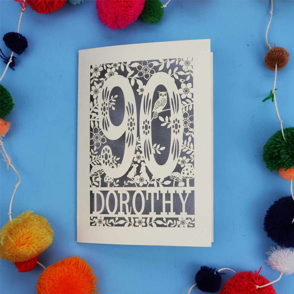 90th Birthday Card with '90 Dorothy' design on a blue background with colourful pom-poms.