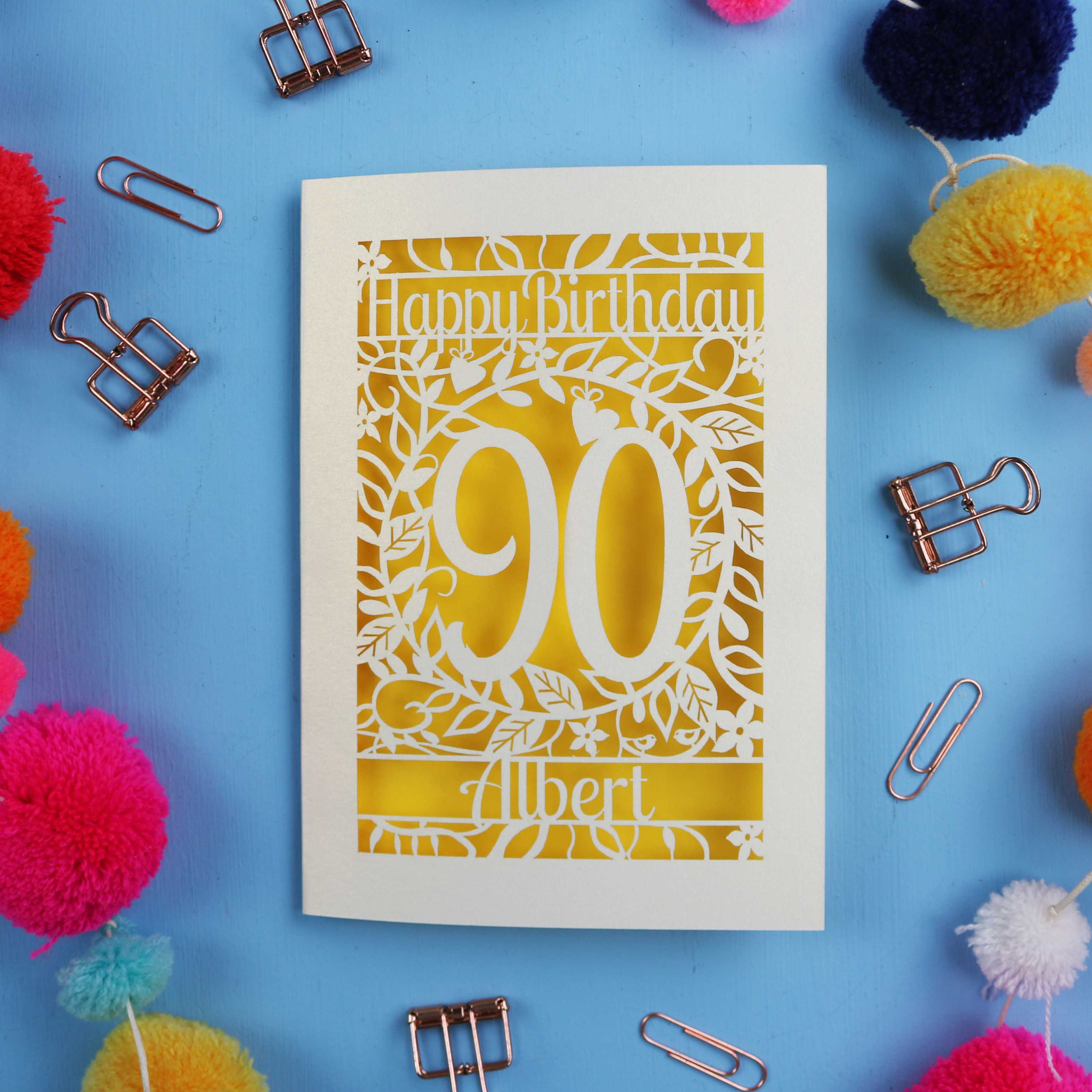 90th Birthday card with 'Happy Birthday 90 Albert' on a blue background with colourful pom-poms and paper clips.