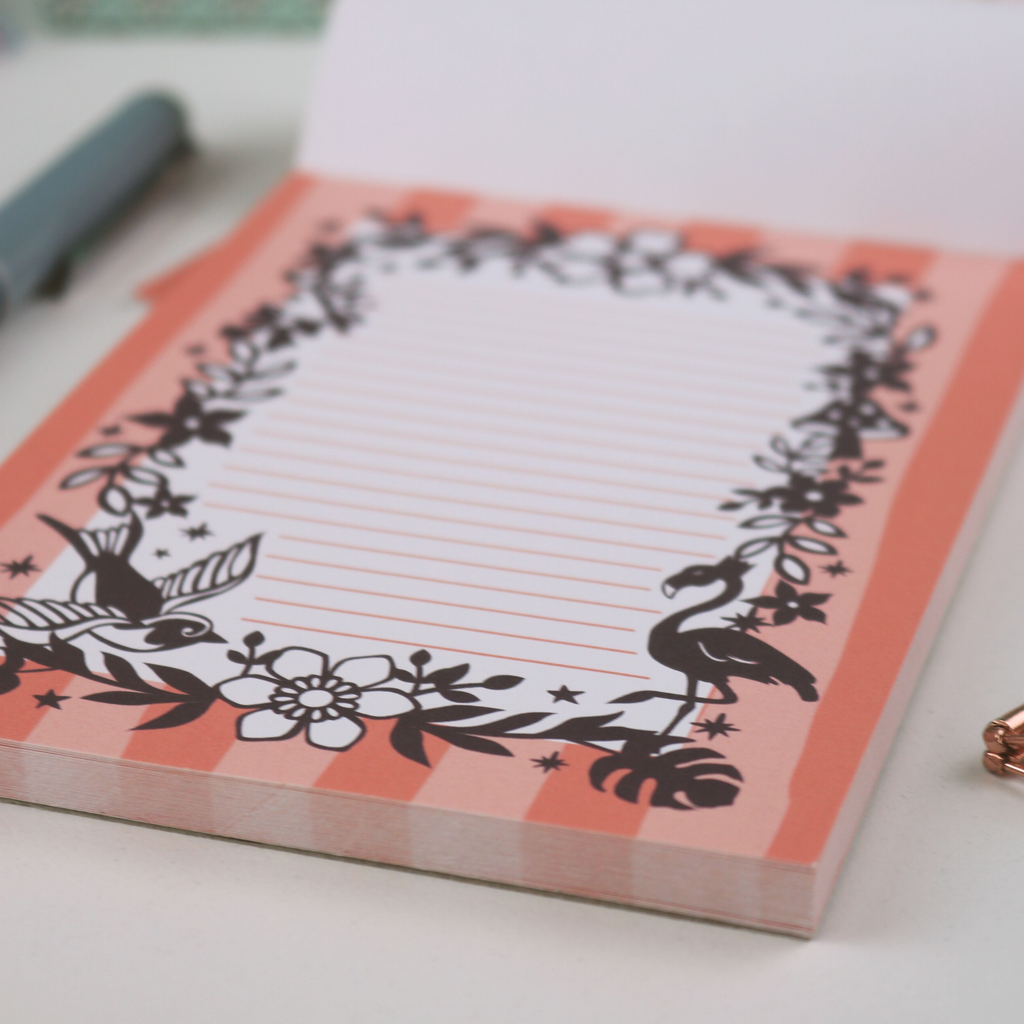 Notebook with decorative flamingo design on a white surface