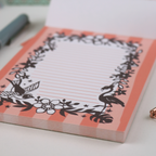 Notebook with decorative flamingo design on a white surface