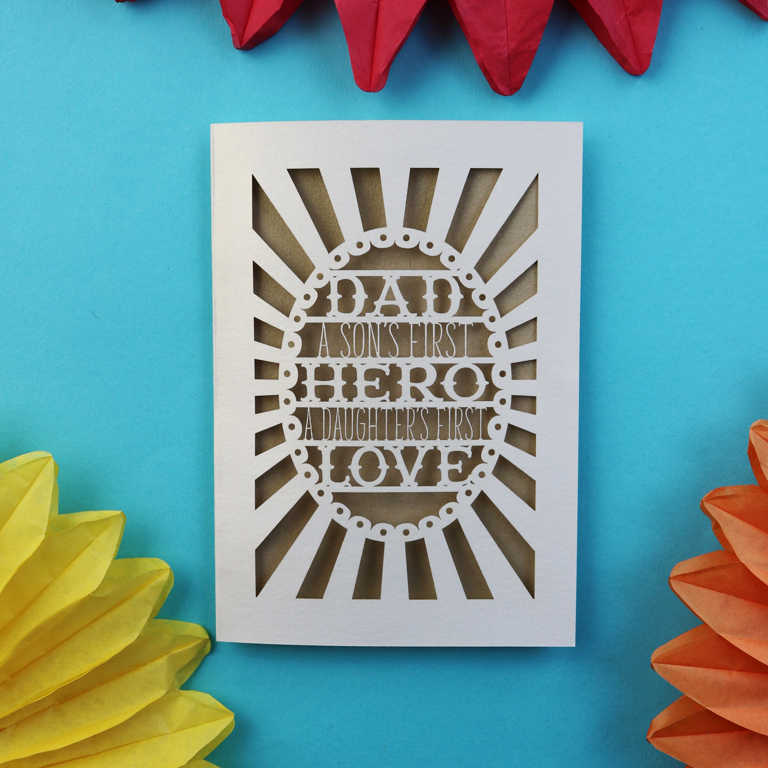 A laser cut unusual father's day card that says "Dad, A son's first hero, a daughter's first love"